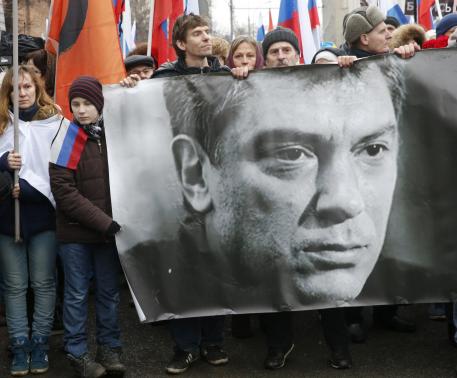 People hold banner of Kremlin critic Nemtsov during march to commemorate him in central Moscow
